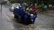 A man drives his motorcycle-cart through a flooded street after recent heavy rain showers in Piura, Peru, Friday, March 10, 2023. (AP Photo/Jao Yamunaque)