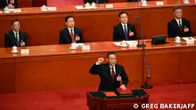 11.03.2023**China's newly-elected Premier Li Qiang takes an oath after being elected during the fourth plenary session of the National People's Congress (NPC) at the Great Hall of the People in Beijing on March 11, 2023. (Photo by GREG BAKER / POOL / AFP)