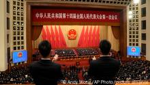 12.03.2023**Security personnel stands to applaud during a session of China's National People's Congress (NPC) at the Great Hall of the People in Beijing, Saturday, March 11, 2023. (AP Photo/Andy Wong)