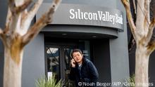 10.03.2023 *** A pedestrian speaks on a mobile telephone as he walks past Silicon Valley Banks headquarters in Santa Clara, California on March 10, 2023. - US authorities swooped in and seized the assets of SVB, a key lender to US startups since the 1980s, after a run on deposits made it no longer tenable for the medium-sized bank to stay afloat on its own. (Photo by NOAH BERGER / AFP) (Photo by NOAH BERGER/AFP via Getty Images)