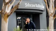 10.03.2023 *** A pedestrian speaks on a mobile telephone as he walks past Silicon Valley Banks headquarters in Santa Clara, California on March 10, 2023. - US authorities swooped in and seized the assets of SVB, a key lender to US startups since the 1980s, after a run on deposits made it no longer tenable for the medium-sized bank to stay afloat on its own. (Photo by NOAH BERGER / AFP) (Photo by NOAH BERGER/AFP via Getty Images)