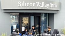10.03.2023 *** SANTA CLARA, CALIFORNIA - MARCH 10: A worker (C) tells people that the Silicon Valley Bank (SVB) headquarters is closed on March 10, 2023 in Santa Clara, California. Silicon Valley Bank was shut down on Friday morning by California regulators and was put in control of the U.S. Federal Deposit Insurance Corporation. Prior to being shut down by regulators, shares of SVB were halted Friday morning after falling more than 60% in premarket trading following a 60% declined on Thursday when the bank sold off a portfolio of US Treasuries and $1.75 billion in shares to cover declining customer deposits. (Photo by Justin Sullivan/Getty Images)