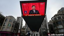 13.03.2023 *** An outdoor screen shows a live news coverage of China’s President Xi Jinping delivering a speech during the closing session of the National People's Congress (NPC) at the Great Hall of the People, along a street in Beijing on March 13, 2023. (Photo by JADE GAO / AFP)