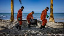 POLA, PHILIPPINES - MARCH 08: Coast guard personnel clean up an oil slick that has washed ashore from the sunken tanker MT Princess Empress on March 08, 2023 in Pola, Oriental Mindoro, Philippines. Authorities are racing to contain an oil spill after an oil tanker sunk off the coast of Oriental Mindoro, south of Manila. The tanker, MT Princess Empress, was carrying 800,000 liters of industrial oil when it sank on February 28 due to engine trouble and rough seas. Marine experts estimate that about 36,000 hectares of coral reefs, mangroves, and seagrass are in danger of being damaged. The spill has also prompted authorities to ban fishing and swimming in contaminated waters, halting the livelihood of countless residents who rely on fishing and tourism to survive. (Photo by Ezra Acayan/Getty Images)