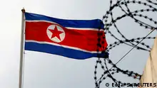 FILE PHOTO: A North Korea flag flutters next to concertina wire at the North Korean embassy in Kuala Lumpur, Malaysia March 9, 2017. REUTERS/Edgar Su/File Photo