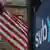 A US flag flies outside a branch of the Silicon Valley Bank in Wellesley, Massachusetts, US