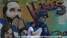 28.02.2023
A pedestrian walks past graffiti showing Salvadoran President Nayib Bukele and a text that reads in Spanish Heros, at a street in the Soyapango neighborhood of San Salvador, El Salvador, Tuesday, Feb. 28, 2023. El Salvador's congress has approved President Bukele's request to extend the period of special powers for another month, meaning the country will go at least a full year with some fundamental rights suspended in itÂ´s fight against gangs. (AP Photo/Salvador Melendez)