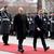 German Chancellor Olaf Scholz and Swedish Prime Minister Ulf Kristersson walk along red carpet in Berlin in front of soldiers standing attention