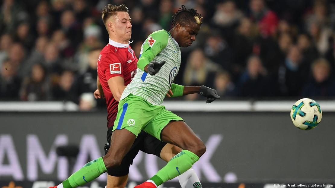 Victor Osimhen, wearing a lime green Wolfsburg kit, challenges for the ball during a Bundesliga game Victor Osimhen, wearing a lime green Wolfsburg kit, challenges for the ball during a Bundesliga game