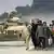 A US tank and refugees fleeing Basra in March 2003