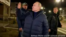 ***Video released by Russian TV Pool.***
In this photo taken from video released by Russian TV Pool on Sunday, March 19, 2023, Russian President Vladimir Putin waves local residents after visiting their new flat during his visit to Mariupol in Russian-controlled Donetsk region, Ukraine. Putin has traveled to Crimea to mark the ninth anniversary of the Black Sea peninsula's annexation from Ukraine. (Pool Photo via AP)