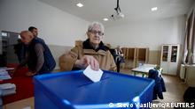 A person votes at a polling station during the presidential elections in Podgorica, Montenegro, March 19, 2023. REUTERS/Stevo Vasiljevic
