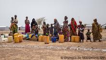 2021***Women queue at the water pump in Goudebou, a camp that welcomes more than 11,000 Malian refugees in northern Burkina Faso, on International Refugee Day on June 20, 2021. - Oscar-winning actor Angelina Jolie on Sunday visited a refugee camp in Burkina Faso sheltering thousands of Malians who have fled jihadist violence in the region. Jolie visited the camp at Goudebou, in the northeast of the landlocked west African country, as part of her role as an ambassador for the UN refugee organisation, the UNHCR. (Photo by OLYMPIA DE MAISMONT / AFP)