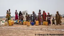 2021***Women queue at the water pump in Goudebou, a camp that welcomes more than 11,000 Malian refugees in northern Burkina Faso, on International Refugee Day on June 20, 2021. - Oscar-winning actor Angelina Jolie on Sunday visited a refugee camp in Burkina Faso sheltering thousands of Malians who have fled jihadist violence in the region. Jolie visited the camp at Goudebou, in the northeast of the landlocked west African country, as part of her role as an ambassador for the UN refugee organisation, the UNHCR. (Photo by OLYMPIA DE MAISMONT / AFP)