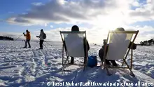 2021****People enjoy sunny weather on ice on waterfront of Helsinki, Finland on February 14, 2021. LEHTIKUVA / JUSSI NUKARI - FINLAND OUT. NO THIRD PARTY SALES.