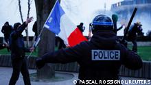 A police officer holds a truncheon, as protesters attend a demonstration, on the day of debates and votes on two motions of no-confidence against the French government, tabled by centrist group Liot and far-right Rassemblement National party, after the use by the French government of article 49.3, a special clause in the French Constitution, to push the pensions reform bill through the National Assembly without a vote by lawmakers, in Lille, France, March 20, 2023. REUTERS/Pascal Rossignol