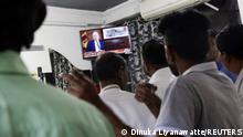 21.03.2023
Supporters of President Ranil Wickremesinghe watch the TV while he addresses the nation, after the International Monetary Fund's executive board approved a $3 billion loan, in outskirts of Colombo, Sri Lanka March 21, 2023. REUTERS/Dinuka Liyanawatte