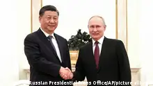 In this handout photo released by Russian Presidential Press Office, Russian President Vladimir Putin, right, and Chinese President Xi Jinping shake hands prior to their talks at the Kremlin in Moscow, Russia, Monday, March 20, 2023. (Russian Presidential Press Office via AP)