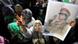 epa02688306 A supporters of Libyan leader Muammar Gaddafi holds his poster in the heavily fortified military barracks and compound of Bab Al Azizia in Tripoli, Libya, 15 April 2011. EPA/MOHAMED MESSARA +++(c) dpa - Bildfunk+++ epa02688306 A supporters of Libyan leader Muammar Gaddafi holds his poster in the heavily fortified military barracks and compound of Bab Al Azizia in Tripoli, Libya, 15 April 2011. EPA/MOHAMED MESSARA +++(c) dpa - Bildfunk+++