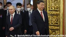 Russian President Vladimir Putin and Chinese President Xi Jinping attend a welcome ceremony before Russia - China talks in narrow format at the Kremlin in Moscow, Russia March 21, 2023. Sputnik/Mikhail Tereshchenko/Pool via REUTERS ATTENTION EDITORS - THIS IMAGE WAS PROVIDED BY A THIRD PARTY.