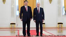 Russian President Vladimir Putin and Chinese President Xi Jinping attend a welcome ceremony before Russia - China talks in narrow format at the Kremlin in Moscow, Russia March 21, 2023. Sputnik/Pavel Byrkin/Kremlin via REUTERS ATTENTION EDITORS - THIS IMAGE WAS PROVIDED BY A THIRD PARTY.