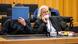 The accused with his face covered, seated next to his defense lawyer The accused with his face covered, seated next to his defense lawyer