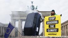 A SUV is piled into the ground in front of Berlin's landmark Brandenburg Gate during a protest stop crashing the climate by Greenpeace in Berlin, Germany, March 22, 2023. REUTERS/Michele Tantussi