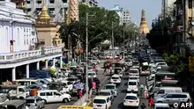 A general view shows traffic along Mahabandoola Road, with Sule Pagoda in the background, in Yangon on January 31, 2023. - Myanmar marks two years on February 1 since the military seized power, ousting the civilian government and arresting its de facto leader, Aung San Suu Kyi. (Photo by AFP)