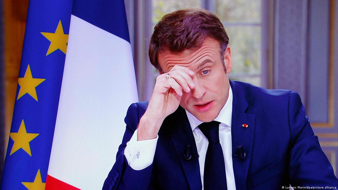 Emmanuel Macron, with raised eyebrows and a hand on his forehead. Image from March 2023.