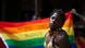 A transgender Ugandan poses in front of a rainbow flag during the 3rd Annual Lesbian, Gay, Bisexual and Transgender (LGBT) Pride celebrations in Entebbe, Uganda A transgender Ugandan poses in front of a rainbow flag during the 3rd Annual Lesbian, Gay, Bisexual and Transgender (LGBT) Pride celebrations in Entebbe, Uganda