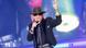 Udo Lindenberg, a man performs on stage wearing a black hat and sunglasses. Udo Lindenberg, a man performs on stage wearing a black hat and sunglasses.