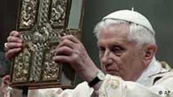 Pope Benedict XVI holds up the book of the Gospels