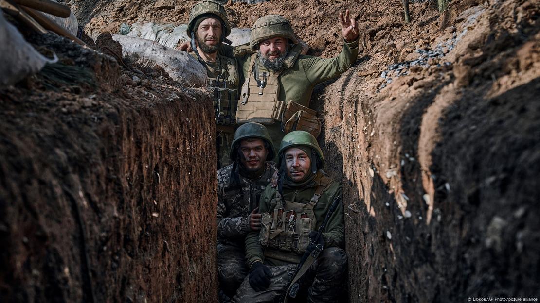 Soldiers pose for photo in trench during fighting with Russian troops near Bakhmut