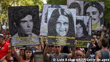 Demonstrators hold portraits of people who disappeared during the military dictatorship (1976-1983) during a march to commemorate the 47th anniversary of the coup at Plaza de Mayo Square in Buenos Aires on March 24, 2023. - About 30,000 people went missing after being arrested during the right-wing military regime accused of being leftist sympathizers or deemed subversive, according to Human Rights organizations. (Photo by Luis ROBAYO / AFP) (Photo by LUIS ROBAYO/AFP via Getty Images)
