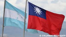 Honduras and Taiwan national flags fly at a square in Tegucigalpa on March 23, 2023. - Taiwan recalled on Thursday its ambassador to Honduras over a visit by Tegucigalpa's foreign minister to China, Taipei's government said in a statement. (Photo by Orlando SIERRA / AFP)