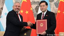Honduras Foreign Minister Eduardo Enrique Reina (L) and Chinese Foreign Minister Qin Gang shake hands following the establishment of diplomatic relations between the two countries, at a ceremony in the Diaoyutai State Guesthouse in Beijing on March 26, 2023. (Photo by GREG BAKER / POOL / AFP)