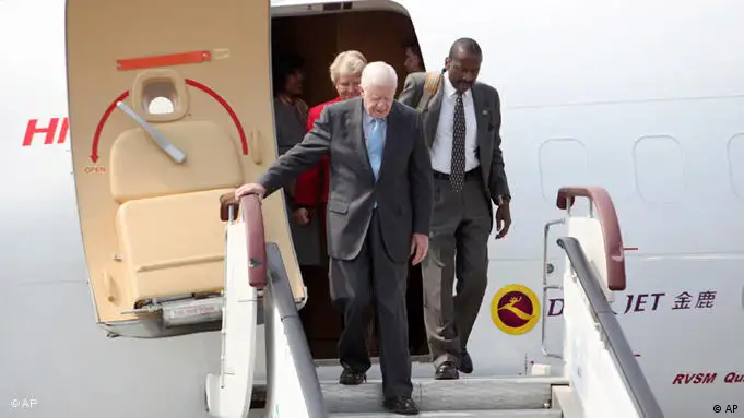 President Jimmy Carter and delegation members disembark a plane upon arrival in Pyongyang