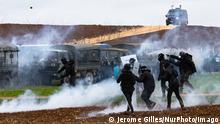 French Police Clash With Water Reservoir Protesters Rotesters, surrounded by tear gas, clash with riot mobile gendarmes during a demonstration called by the collective Bassines non merci , the environmental movement Les Soulevements de la Terre and the French trade union Confederation paysanne to protest against the construction of a new water reserve for agricultural irrigation, in Sainte-Soline, central-western France, on March 25, 2023. More than 3,000 police officers and gendarmes have been mobilised and 1,500 activists are expected to take part in the demonstration, around Sainte-Soline. The new protest against the bassines , a symbol of tensions over access to water, is taking place under thight surveillance on March 2 PUBLICATIONxNOTxINxFRA Copyright: xJeromexGillesx originalFilename: chobeaux-megabass230325_npLaq.jpg