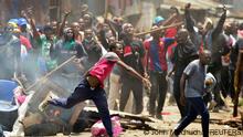 27.03.2023 *** Supporters of Kenya's opposition leader Raila Odinga of the Azimio La Umoja (Declaration of Unity) One Kenya Alliance, throw stones at riot police officers as they participate in a nationwide protest over cost of living and President William Ruto's government in Mathare settlement of Nairobi, Kenya March 27, 2023. REUTERS/John Muchucha TPX IMAGES OF THE DAY 