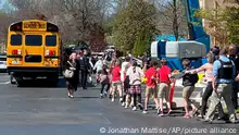 Children from The Covenant School, a private Christian school in Nashville, Tenn., hold hands as they are taken to a reunification site at the Woodmont Baptist Church after a deadly shooting at their school on Monday, March 27, 2023. (AP Photo/Jonathan Mattise)