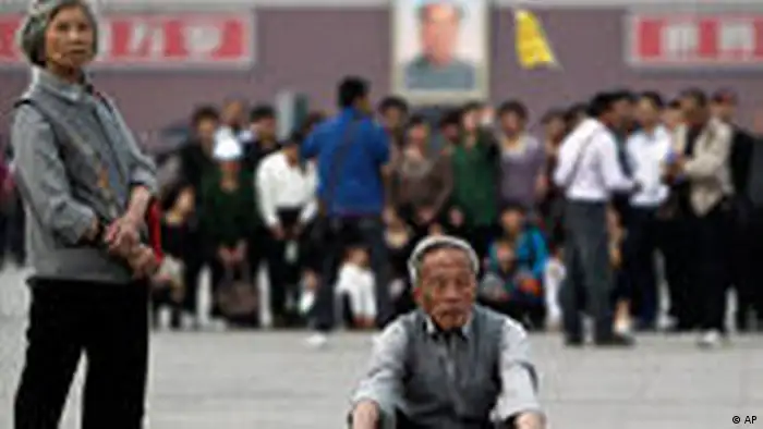 Elderly Chinese people look as they visit the Tiananmen Square in Beijing, China Thursday, April 28, 2011. China's population is aging rapidly and half the people now live in cities, the government said Thursday. The data from a national census carried out late last year will fuel debate about whether China should continue with its one-child policy, experts said. (AP Photo/Andy Wong)