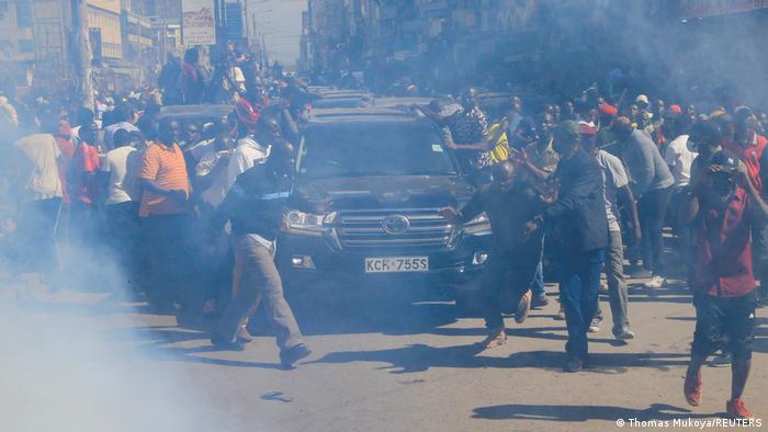 Der Autokonvoi von Raila Odinga mitten in einer protestierenden Menschenmenge, umgeben von Rauschschwaden der Tränengaspatronen