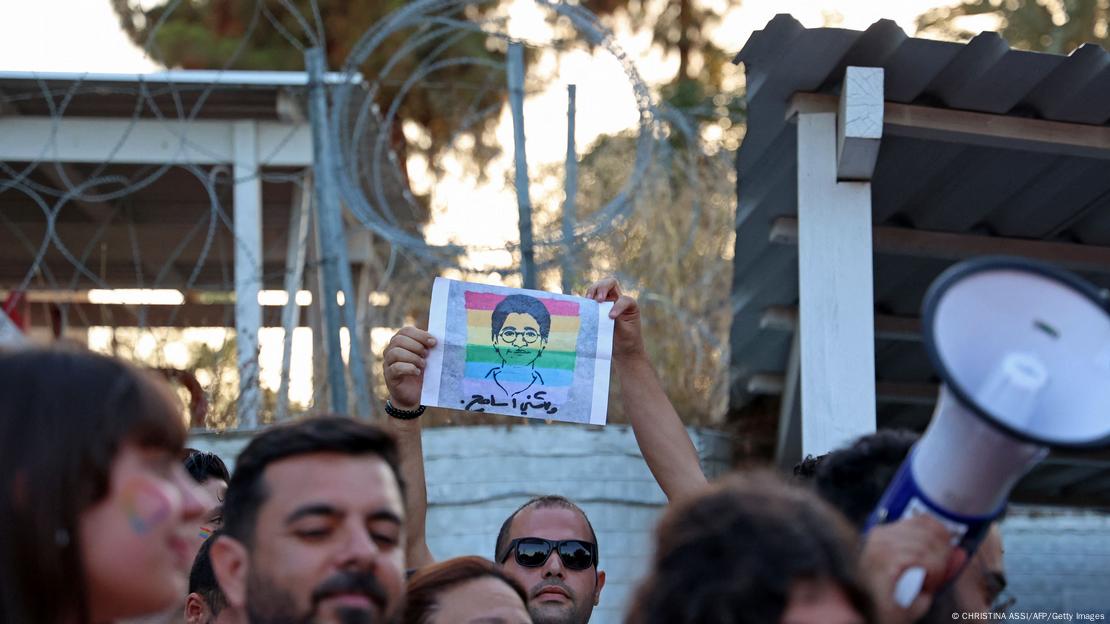 A participant holds up a silhouette picture depicting the late Egyptian LGBTQI activist Sarah Hegazi coloured with the rainbow flag during Cyprus' first intercommunal pride parade in 2022