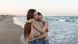 A lesbian couple at the beach, hugging gently A lesbian couple at the beach, hugging gently