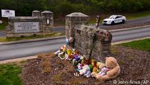 A make shift memorial is seen at the entry to Covenant School with a police car guarding, on Tuesday, March 28, 2023, in Nashville, Tenn. The former student who shot through the doors of the Christian elementary school and killed three children and three adults had drawn a detailed map of the school. (AP Photo/John Amis)