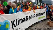 Swiss seniors are protesting outside the European Court of Human Rights Wednesday, March 29, 2023 in Strasbourg, eastern France. A group of Swiss seniors are taking their government to the European Court of Human Rights to demand more action on climate change which, they say, is seriously affecting their lives. (AP Photo/Jean-Francois Badias)