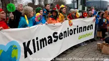 Swiss seniors are protesting outside the European Court of Human Rights Wednesday, March 29, 2023 in Strasbourg, eastern France. A group of Swiss seniors are taking their government to the European Court of Human Rights to demand more action on climate change which, they say, is seriously affecting their lives. (AP Photo/Jean-Francois Badias)