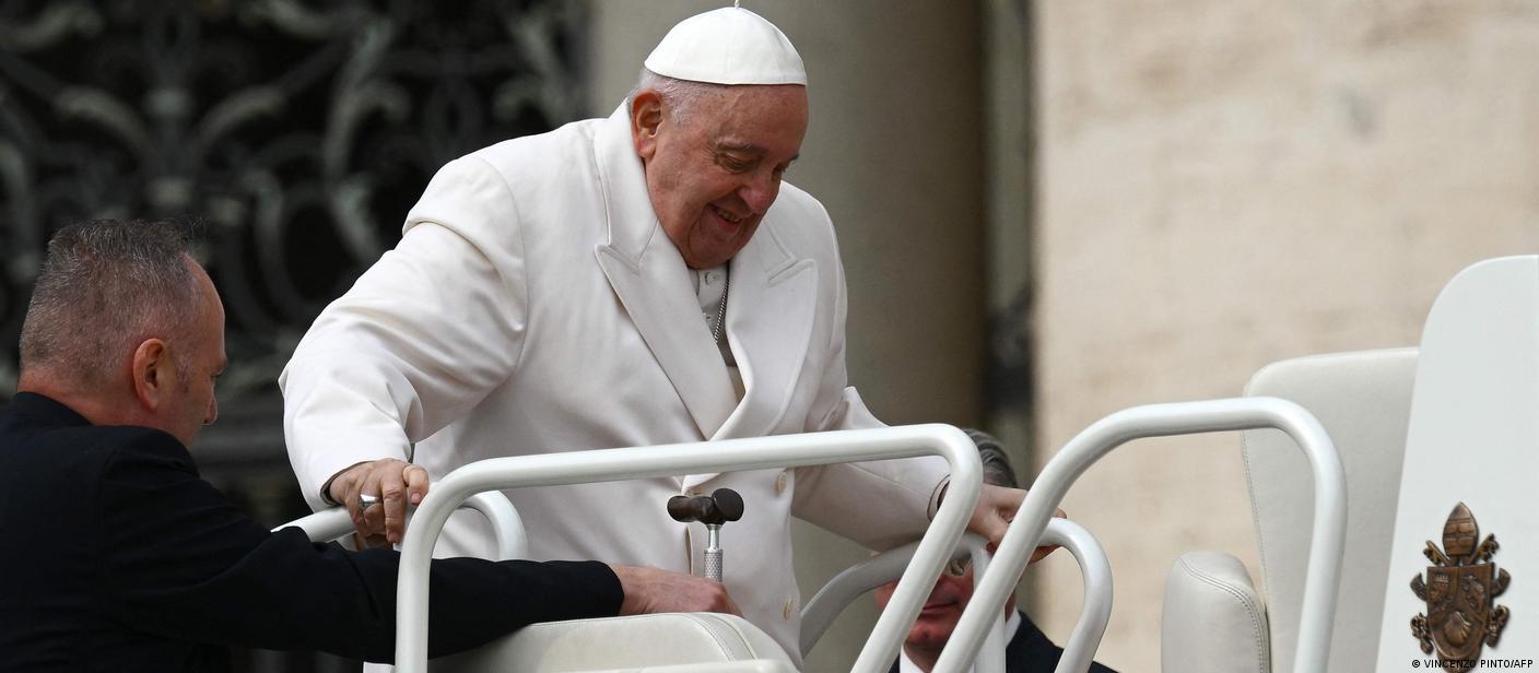 Pope Francis is helped get up the popemobile car as he leaves on March 29 at the end of the weekly general audience at St. Peter's square in The Vatican