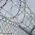 Razor wire at the top of a prison gate