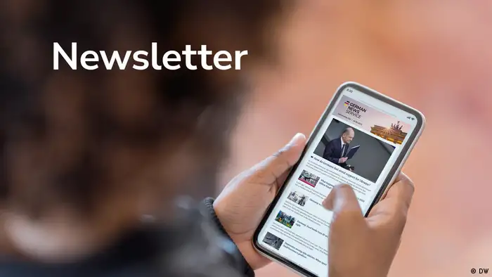 The word Newsletter is printed on a picture of a person holding a mobile phone.